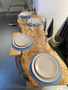 a wooden table with plates and wine glasses on it at Mooi Genieten Studio in Middelburg