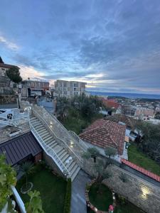 a stairway leading to a building with a city at Alesio Guest House in Krujë