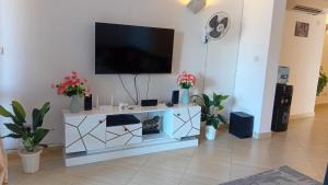 a living room with a tv on a wall at Palm breeze seafront shanzu in Shanzu