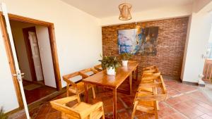 a dining room with a wooden table and chairs at Circle of Life in Baudhatinchule