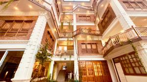 a large building with balconies on the side of it at Circle of Life in Baudhatinchule +34 photos