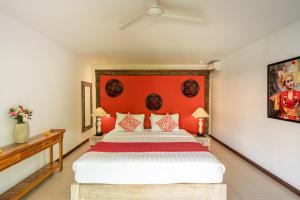 a bedroom with a large bed with an orange headboard at 3BDR Villa with Pool Jacuzzi - Canggu in Dalung