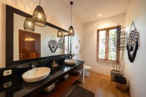 a bathroom with two sinks and a large mirror at 3BDR Villa with Pool Jacuzzi - Canggu in Dalung