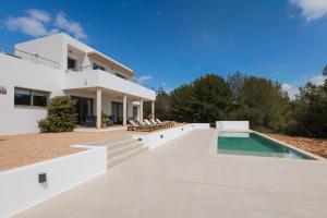 an exterior view of a house with a swimming pool at Villa Es Redo-Spacious & Relax in Sant Josep de sa Talaia