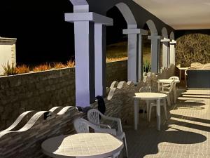 a group of chairs and tables on a patio at Djabraba's space in Garça