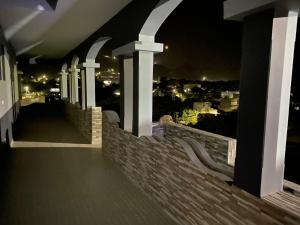 a balcony of a house with a view at night at Djabraba's space in Garça +1 photo