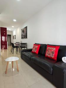 a black leather couch in a living room with a table at Silver House 96 ideal parejas in Arrecife