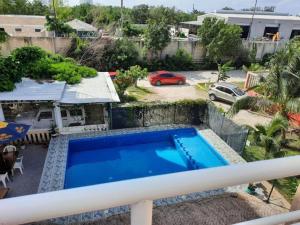a pool on the balcony of a house at Caribbean apartment in private area in Cancún