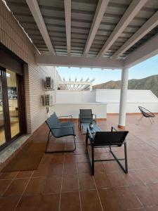 a patio with chairs and a table on a building at Casa Xandra in Tabernas
