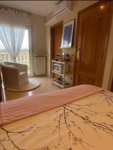 a hotel room with a bed and a window at Habitación Atalaya in Olivella