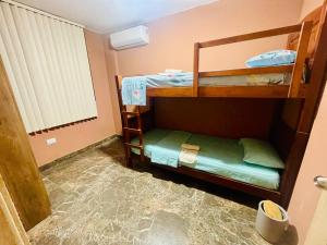 two bunk beds in a room with water on the floor at Dulce & Guanábana suite House in Canoa