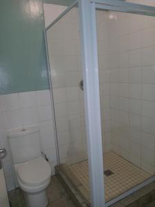a bathroom with a toilet and a shower at Star Legend lodge in Parow