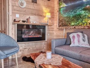 a living room with a couch and a fireplace at Kunatówka domek w Zębie in Ząb +14 photos