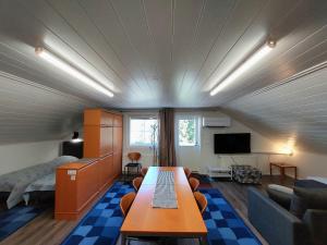 a room with a bed and a table in a room at Penthouse with a balcony in Hyvinkää