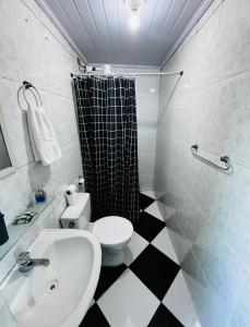 a bathroom with a toilet and a sink and a shower at Casa de praia em Itacuruçá in Mangaratiba +24 photos