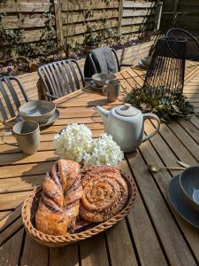 a table with a plate of bread and a teapot at Ferienwohnung Strizi inkl Chiemgau Karte in Ruhpolding