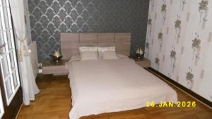 a bedroom with a large bed with white sheets at Le Bel Isle in Echinghen +9 photos