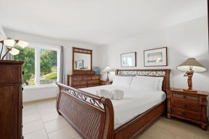 a bedroom with a large bed and a window at Oceanfront 3BR Condo, Balcony, Fire Pit, Shared Beach, Sleeps 6 in Oceanside