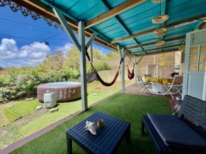 a patio with a hammock and a swing at Kaz a Ma-Lu in Le Marin