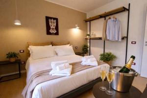 a bedroom with a bed with a bottle of champagne at Noor Palace - PI Collection Hotel in Palermo