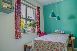 a dining room with a table and a window at Bøllingsø Bed and Breakfast in Engesvang