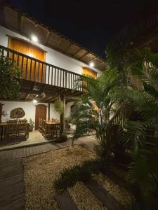 a house with a deck and a patio at night at Pousada Dendê Caraiva in Caraíva