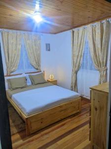 a bedroom with a bed in a room with windows at villa EMMANUEL -2 in Belanitra