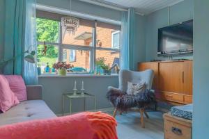 a living room with a couch and a window at Bøllingsø Bed and Breakfast in Engesvang