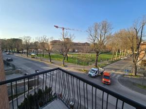 a view of a street with cars parked on the road at Central Chic Apartment in Imola