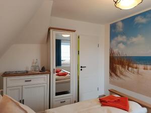 a bedroom with a bed and a painting of the ocean at Ferienhof Maikito in Lalendorf