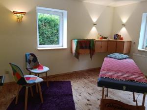 a bedroom with a bed and a table and chairs at Ferienhof Maikito in Lalendorf