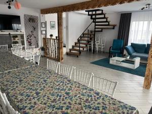 a living room with a staircase and a living room with a rug at Cezar House in Codlea