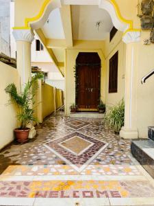 a front door of a house with a tile floor at Pavani staycation in Medchal