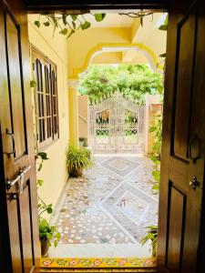 an open door to a courtyard with a gate at Pavani staycation in Medchal