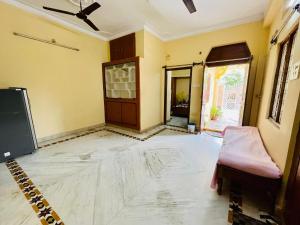 an empty room with a large white marble floor at Pavani staycation in Medchal