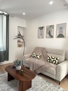 a living room with a couch and a coffee table at Terrasse - CLIM - Arènes à pied - 4 pers in Nîmes