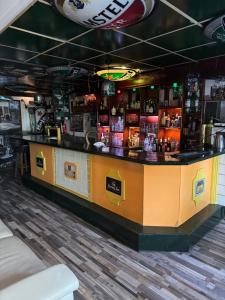 a bar in a restaurant with a yellow counter at Slotje in Egmond aan den Hoef