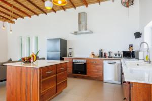 a large kitchen with wooden cabinets and appliances at Villa Pandora in Wok Tum