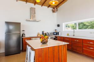 a kitchen with wooden cabinets and a stainless steel refrigerator at Villa Pandora in Wok Tum +68 photos