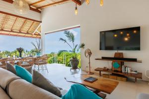 a living room with a couch and a tv at Villa Pandora in Wok Tum