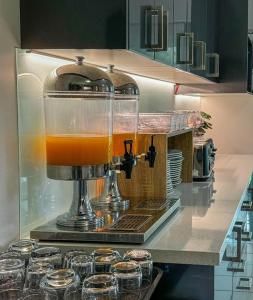 a mixer sitting on top of a counter with glasses at Heritage Cairns Hotel in Cairns