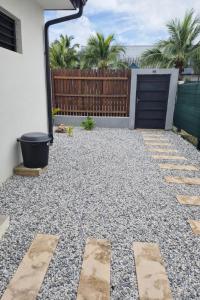 a patio with a fence and a driveway at Private Suite in Kourou