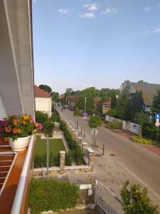 a view of a street with flowers on a balcony at Nyárfa Vendégház in Balatonmáriafürdő +17 photos