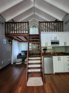 a room with two bunk beds and a kitchen at Enchanted Jungle Treehouse in Spanish Lookout