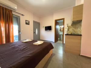 a bedroom with a bed with two towels on it at Villa Georgia beach in Neos Marmaras