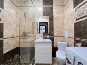 a bathroom with a toilet and a shower at Delicious Aparts in Odesa +27 photos