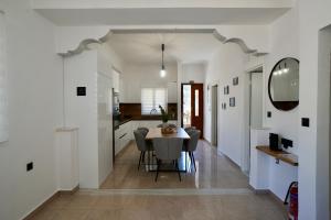 a dining room and kitchen with a table and chairs at BellaDiAnna Apartment in Symi