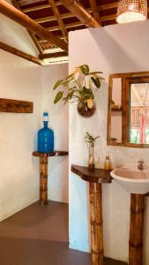 a bathroom with a sink and a mirror at La Caleta Rooms in Mompiche +17 photos
