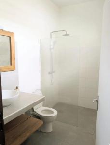 a bathroom with a shower and a toilet and a sink at Private Suite in Kourou +9 photos