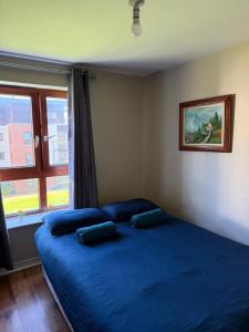 a bedroom with a blue bed with two pillows on it at Superb 3-Bed Residence Airport in Dublin